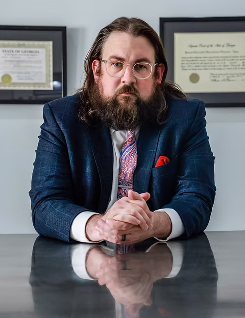 A picture of me in a suit at a conference table.